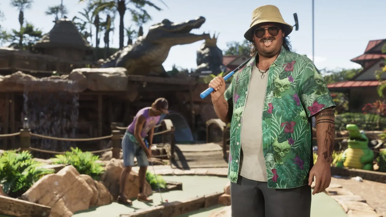 Cal Hampton holding a golf club at an alligator-themed mini golf course