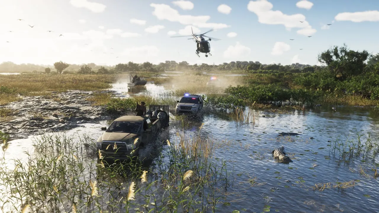 A pickup truck and police cars splashing through the Grassrivers wetlands, a helicopter overhead