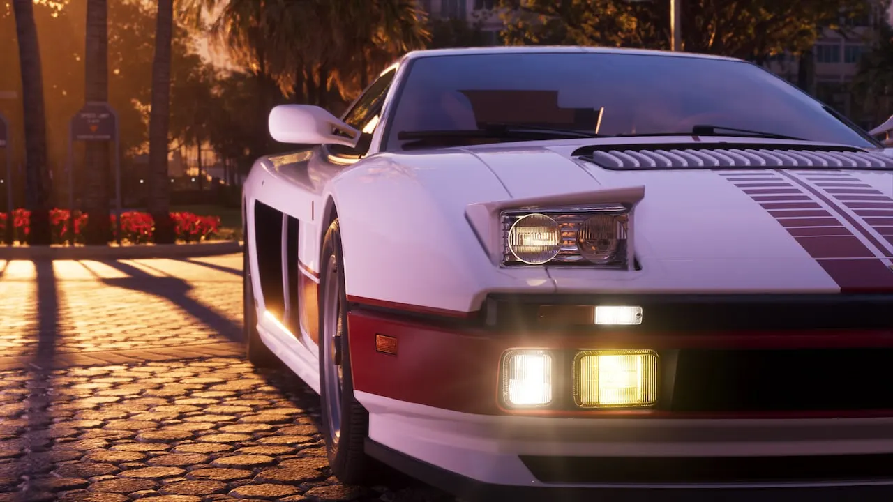 Close-up of a white '95 Grotti Cheetah's front, lights on, on a brick drive at sunset