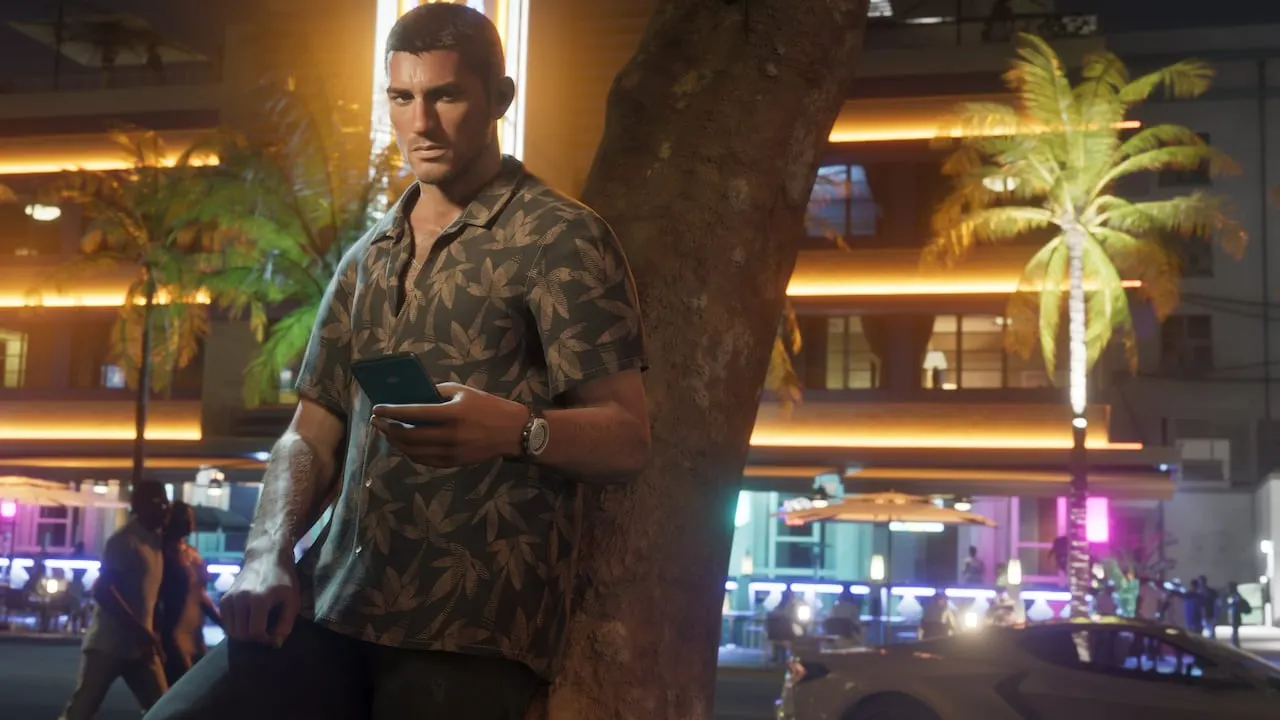 Jason holding his phone outside neon-lit bars at night
