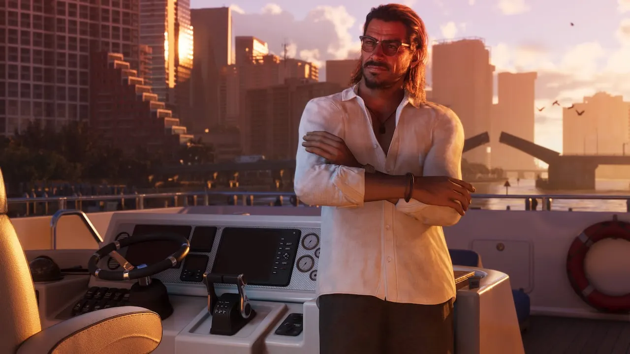 Raul Bautista with his arms crossed on the deck of a boat, city towers behind him at sunset