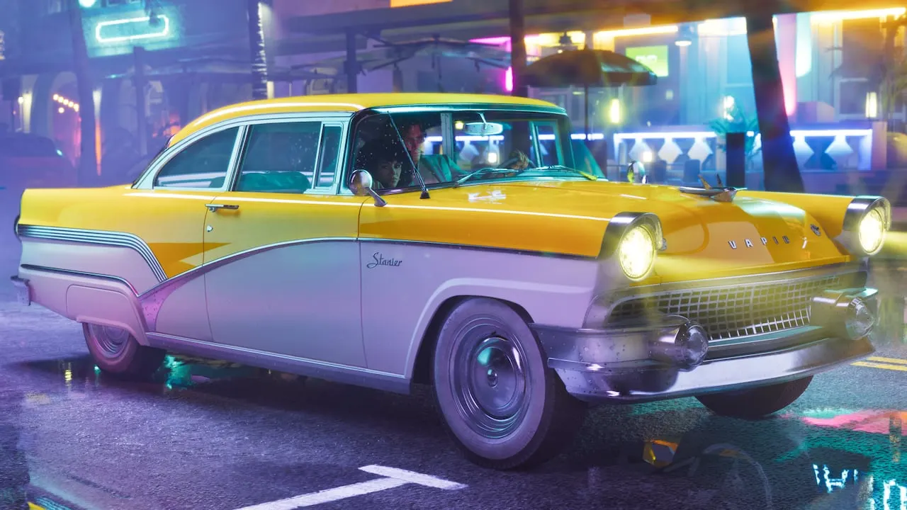 A yellow and white '55 Vapid Stanier under neon lights on a wet street
